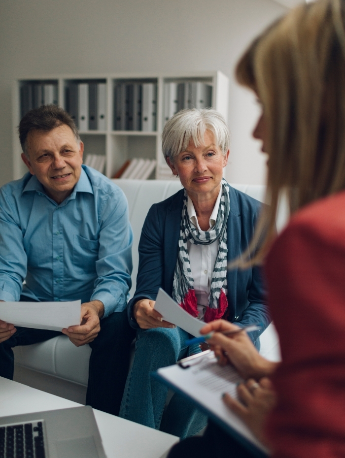 A couple reviewing the financial side of a home purchase with their realtor